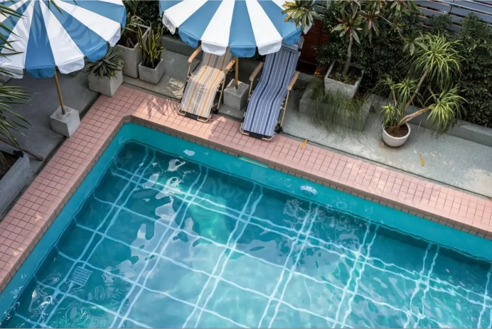 Poolside with striped umbrellas and lounge chairs