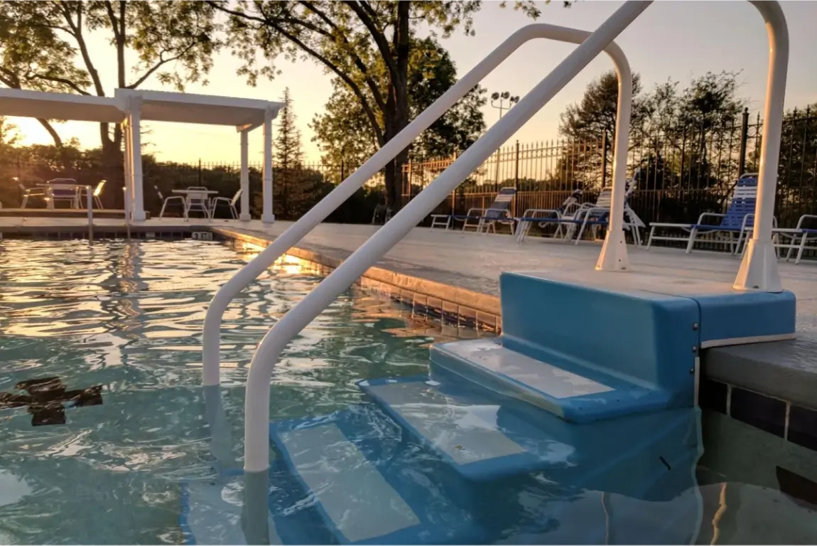 Swimming pool at sunset with steps