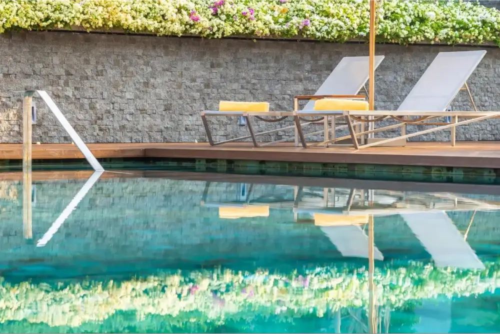 Poolside loungers with floral backdrop