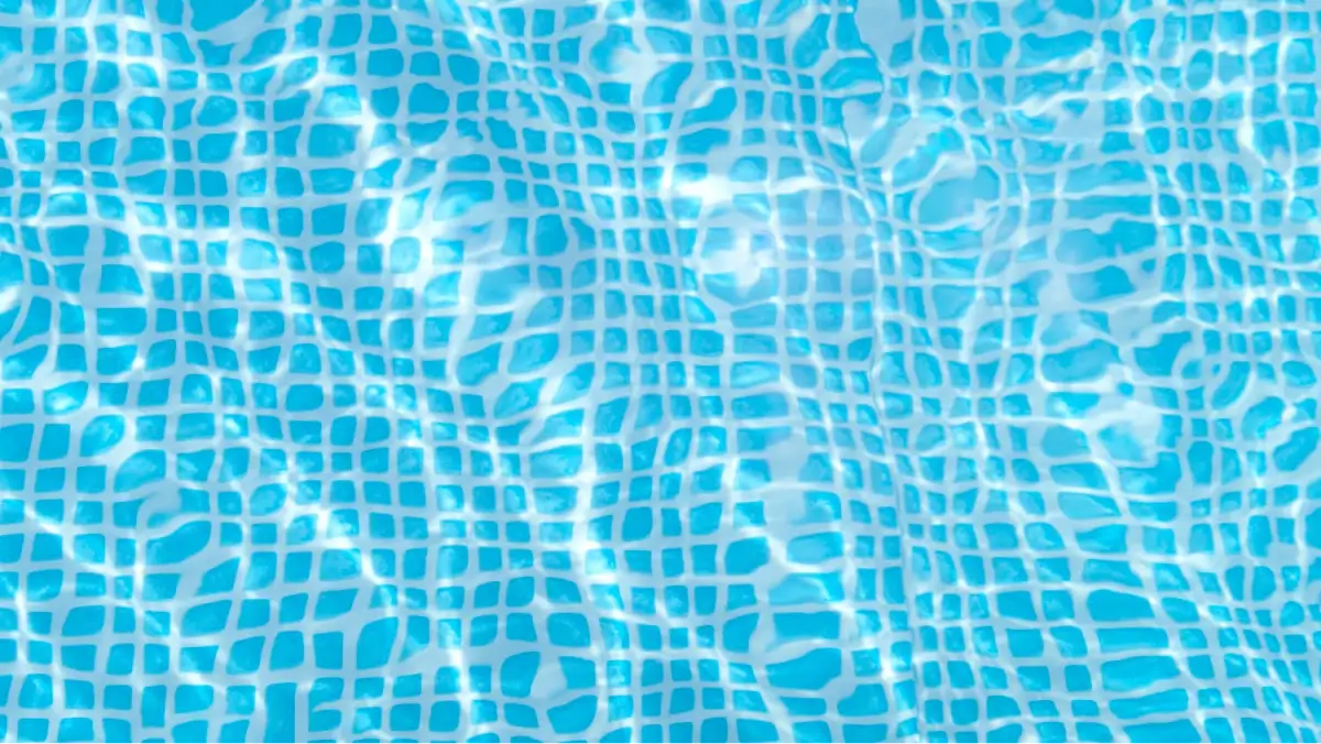 Top-down view of a swimming pool with water reflecting a wavy grid pattern.